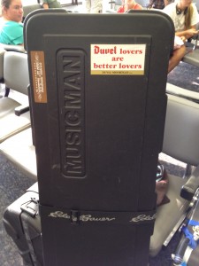 Bass guitar case with a Duvel sticker on it