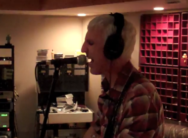 Tony wearing headphones and singing in the studio control room